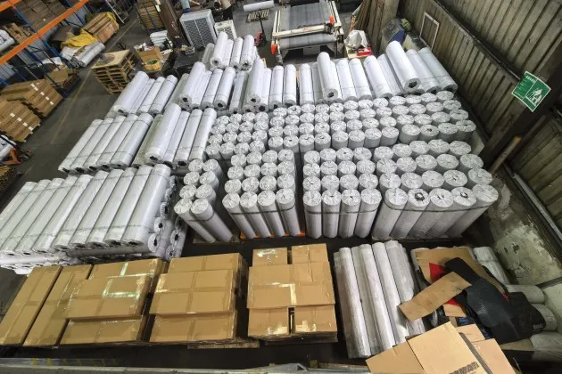 Rolled mat materials and packed cartons in the ARTES supplier facility