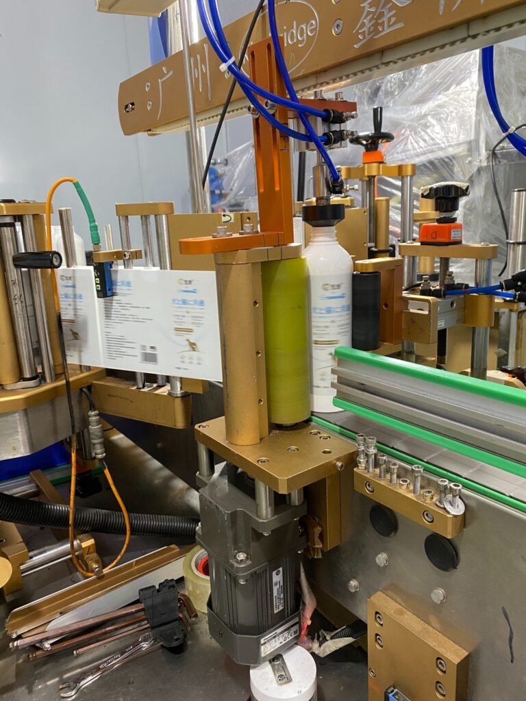 Label application to branded pet-care bottles on a production line